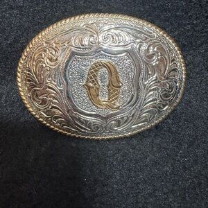 Men’s Silver and Gold belt buckle with the initial “Q”
